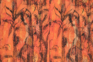 Textile with a black foliate pattern against an orange and yellow background.