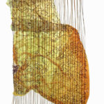 A large crumpled swatch of partially translucent yellow fabric is suspended amongst a loom-like pattern of long vertical threads.