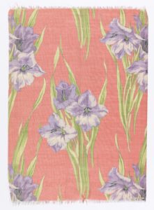 Purple flowers with green stems are grouped in trios against a pastel salmon background.