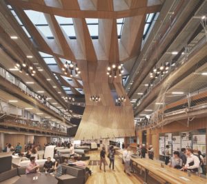 The interior of a massive, well-lit atrium with sweeping, geometrically-patterned wood paneling across the ceiling and back wall.