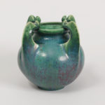 A vase with a shiny green glaze