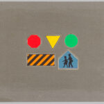 Five colorful traffic symbols pasted onto gray paper.