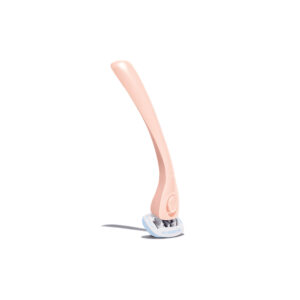 A shaving razor facing downward, with a peach-colored handle above and the white razor touching a white surface.