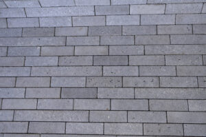 Photograph of horizontal grey rectangular tiles.