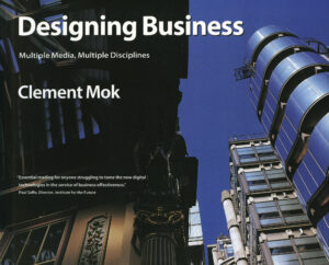 A book cover image featuring a photo looking upward at city buildings with a blue sky, the title reads “Designing Business: Multiple Media, Multiple Disciplines.”