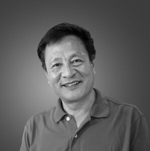 Black and white headshot image of a man wearing a polo shirt.