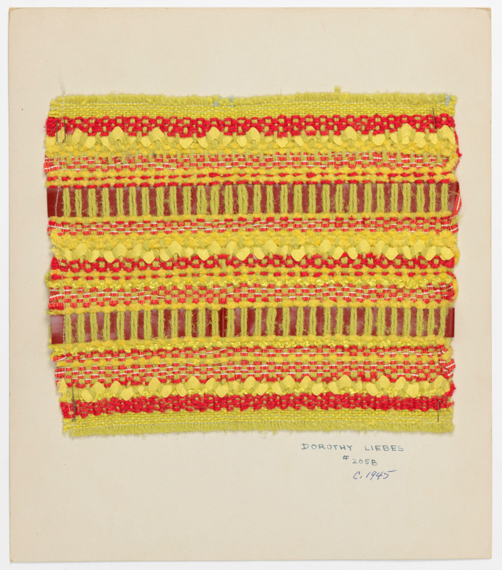 A textured, woven fabric sample in vibrant yellows and reds.