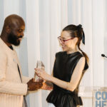 On stage, Nu Goteh accepts a glass National Design Award from Maria Nicanor.