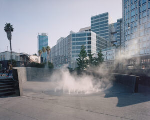 An outdoor rounded concrete ramp that surrounds a circular pool of water in front of the City Ballet of San Francisco.