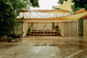 A serene, shaded outdoor nursery made of smartly recycled materials.
