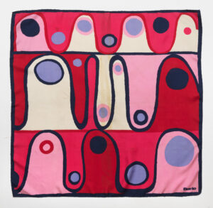 Square decorated with waves colored red, cream, and pink with different size dots of those colors and blue.