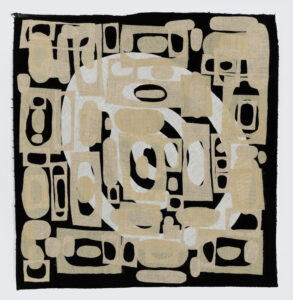 Black background square with central white oval design, tan rectangles with oval cut outs of various sizes cover the square