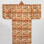 Golden yellow robe with long sleeves. A tree, leaf, and wooden fence pattern repeats in autumnal colors.