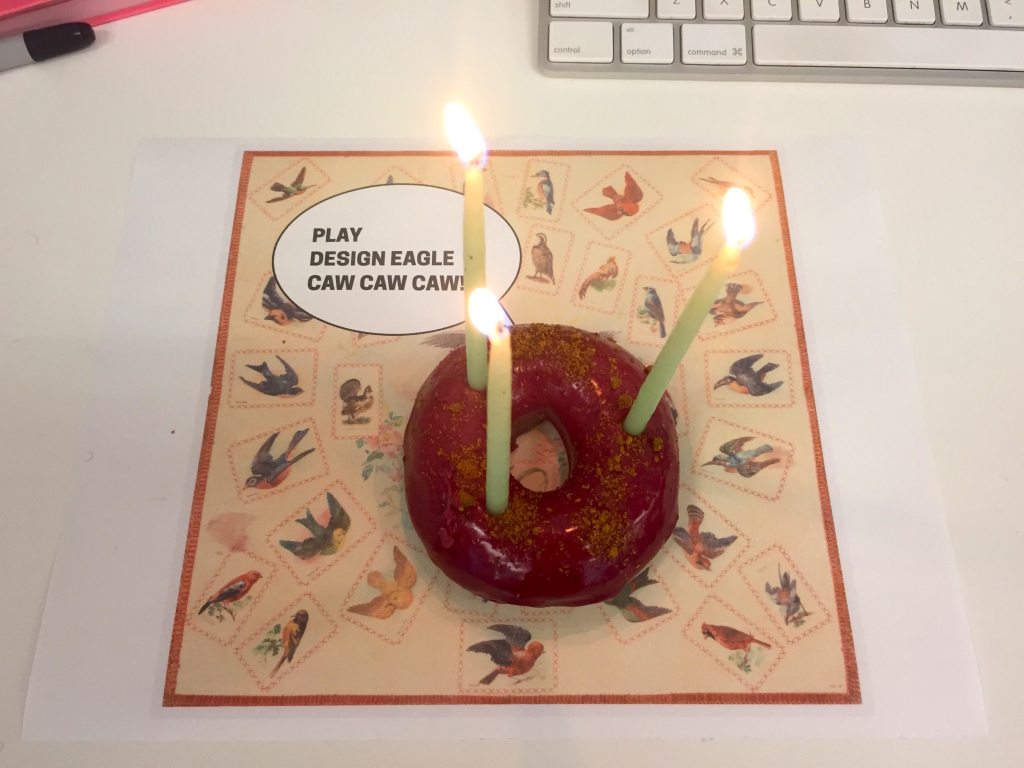 Candles atop a blackberry and giner donut