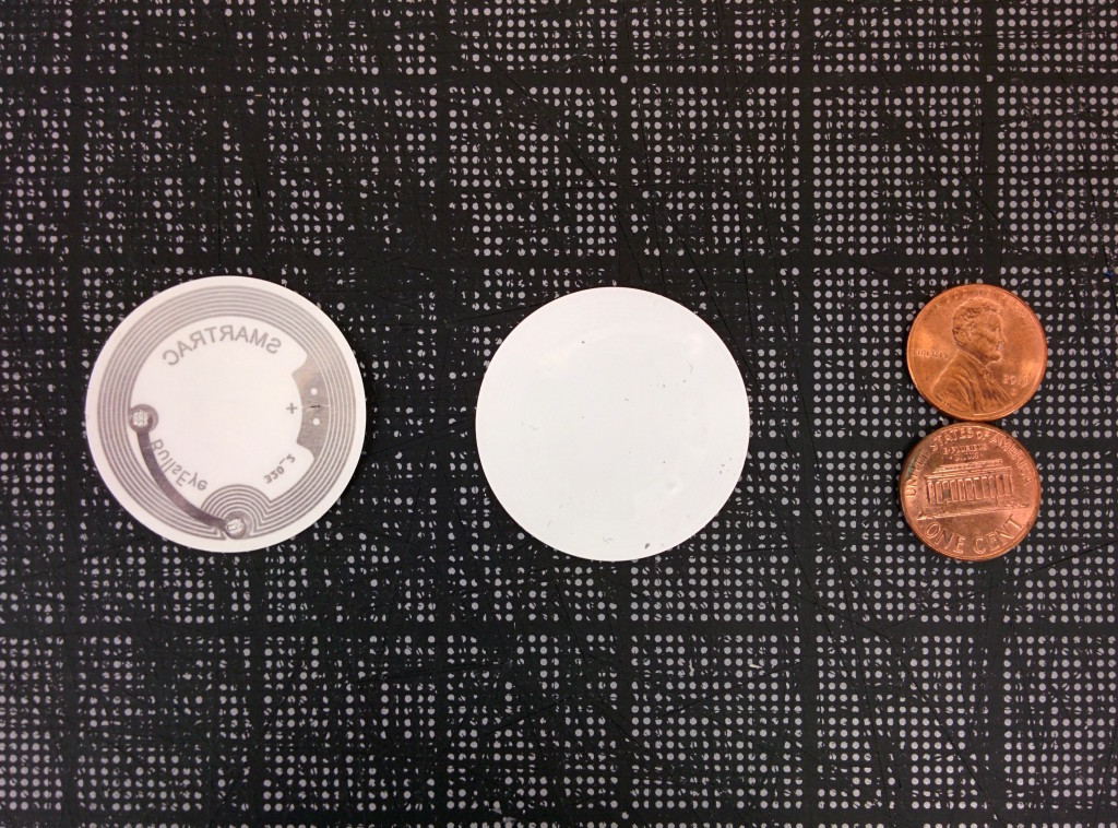 The front and back of the NFC tag we use in our labels, with pennies for scale
