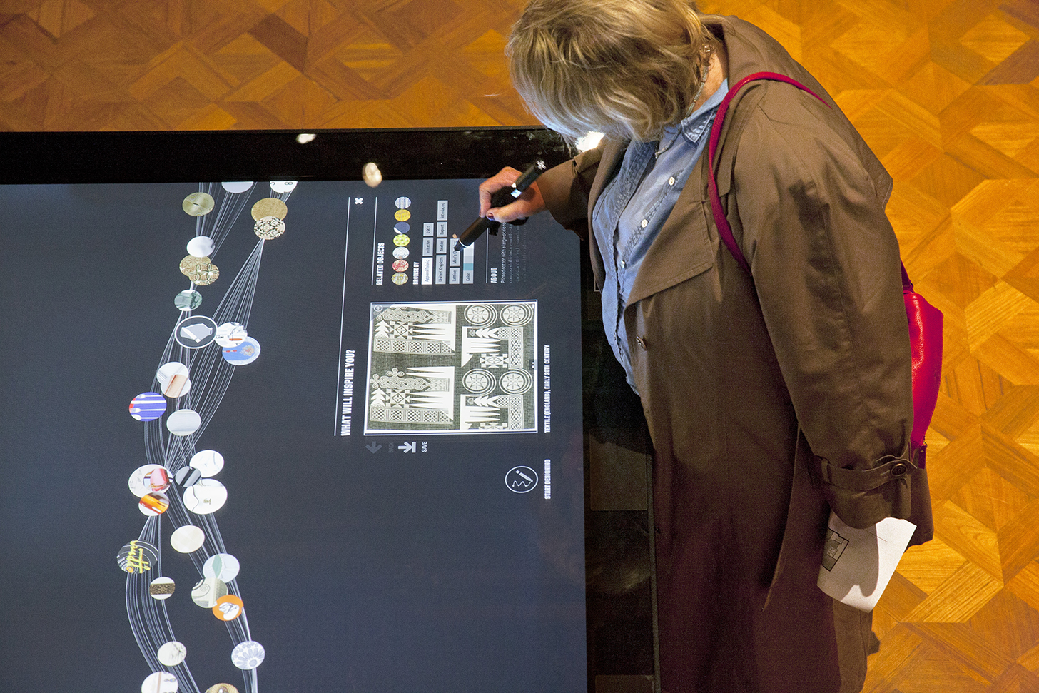 A museum visitor looking at an image on the Digital Table. Photo by Matt Flynn.